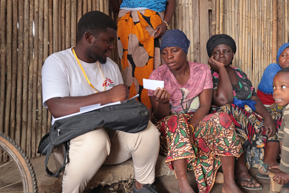 Issa Manzi Makaburi, promotor de MSF, apoyando a una mujer en el campo de personas desplazadas de Mueda