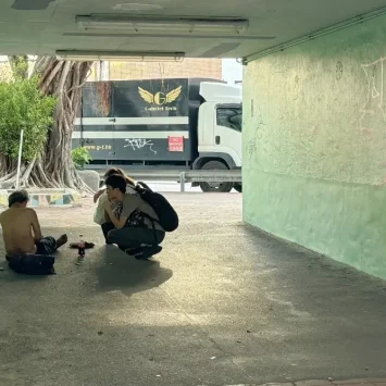 Un miembro del personal de MSF atiende a una persona sin hogar en un paso subterráneo sombreado en Hong Kong. Diciembre de 2024.