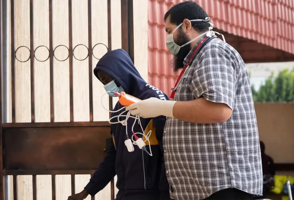 Un médico de MSF lleva a un paciente sospechoso de tuberculosis a la sala de consulta en Zuwara, Libia. Noviembre de 2024.