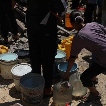 Una niña recolectando agua en la Franja de Gaza.