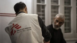 Dr Khaled Al-Shawwa is performing a minor surgery at the MSF clinic in Gaza City. Palestine, December 2024.