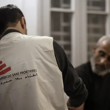 Dr Khaled Al-Shawwa is performing a minor surgery at the MSF clinic in Gaza City. Palestine, December 2024.